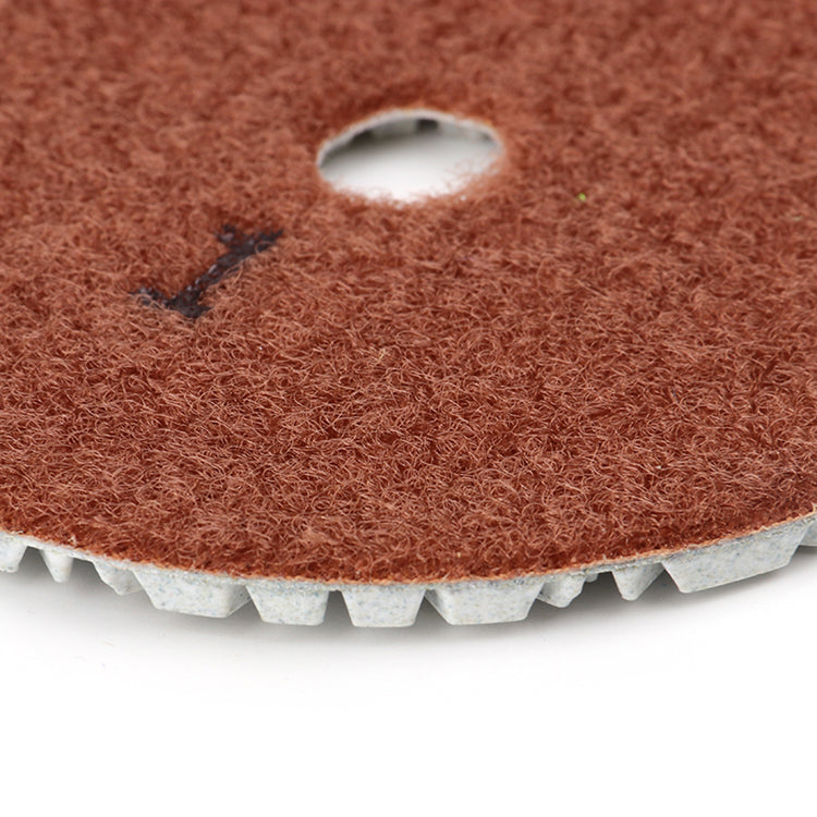Close-up 3-step diamond polishing pad flower star segment pattern optimized debris removal prevents heat buildup